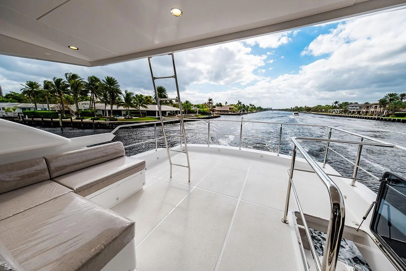 The aft deck offers a spacious and inviting area with comfortable seating and a beautiful view of the waterway. aboard INDIGO Yacht for Sale
