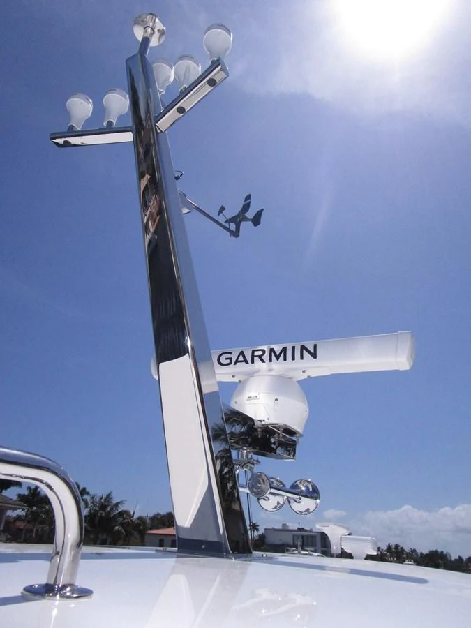 A close-up view of the yacht's advanced navigation and communication equipment under a clear blue sky. aboard INDIGO Yacht for Sale