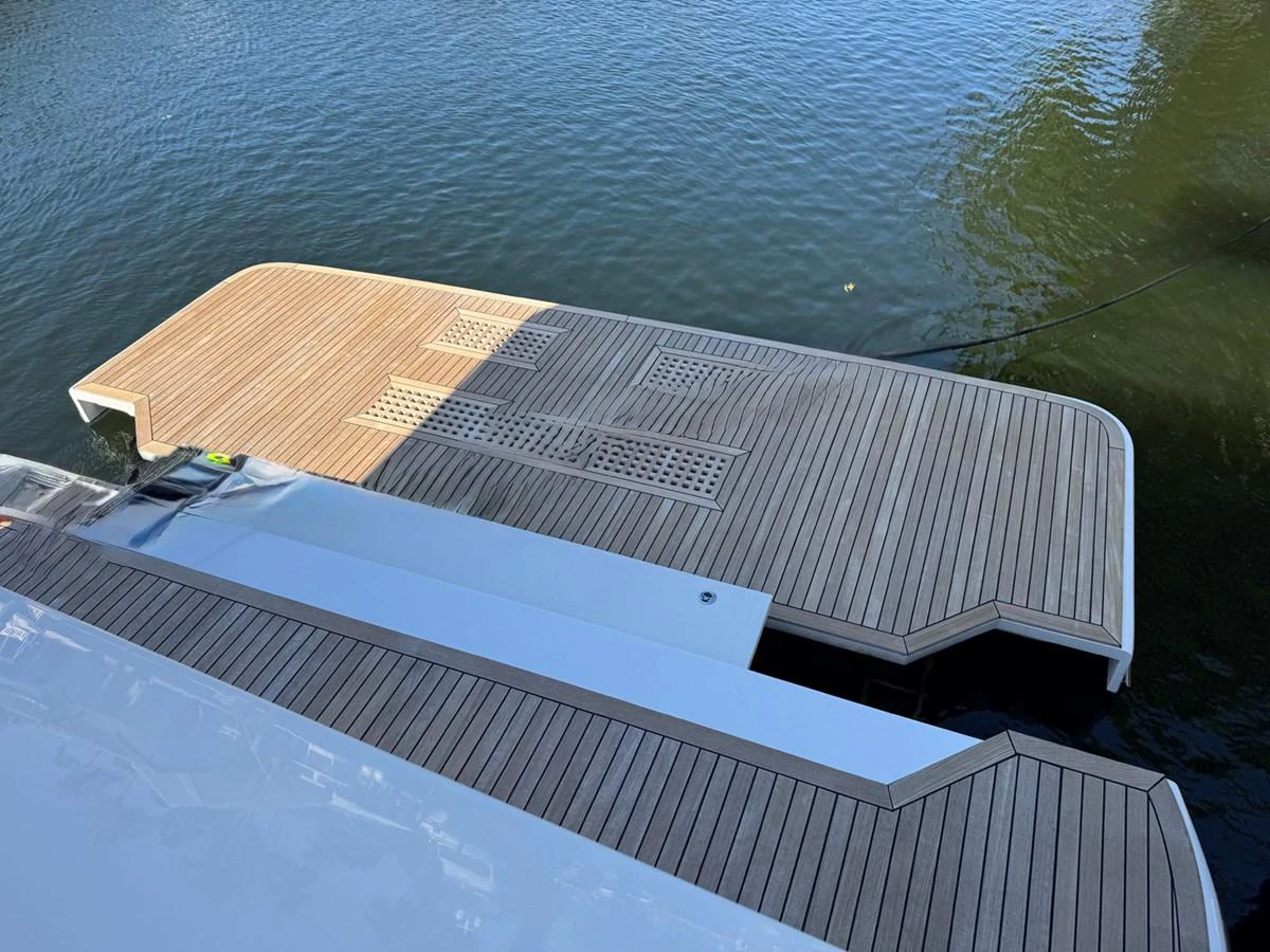 The yacht features a spacious swim platform with elegant wooden decking, perfect for easy water access. aboard INDIGO Yacht for Sale