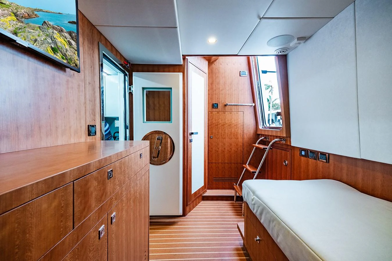 A cozy cabin with wooden finishes and a comfortable bed, perfect for relaxation. aboard INDIGO Yacht for Sale