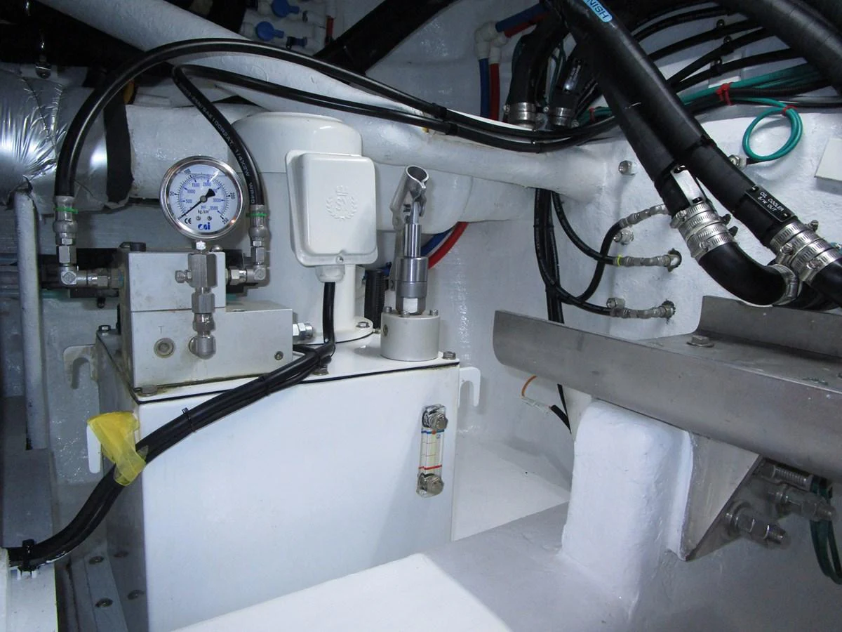 A close-up view of the yacht's engine room showcasing various mechanical components and piping. aboard INDIGO Yacht for Sale