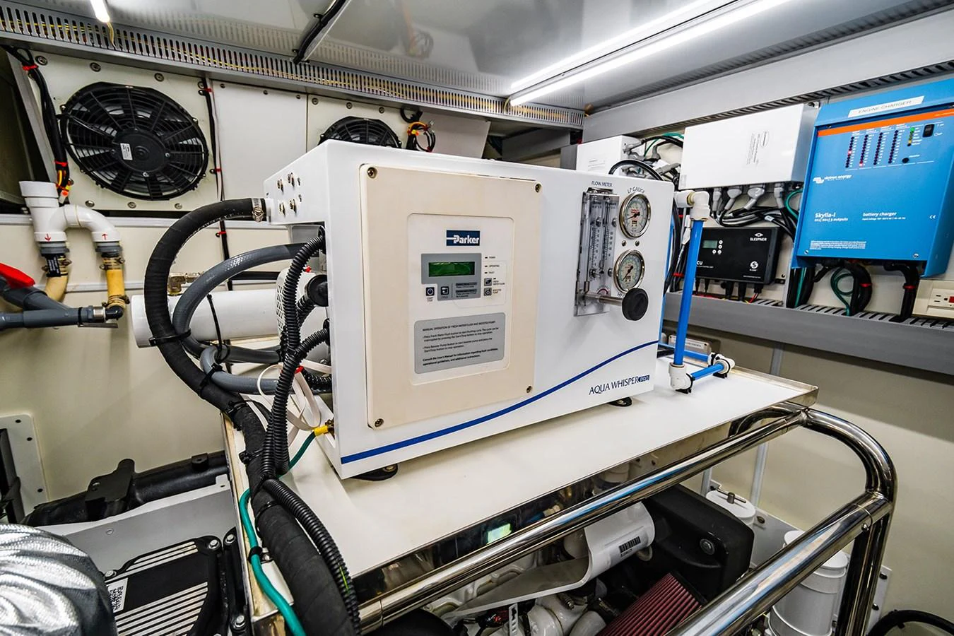The image showcases the technical equipment and machinery in the yacht's engine room. aboard INDIGO Yacht for Sale