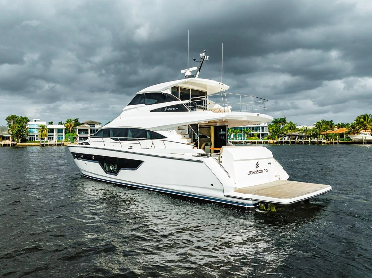 A sleek and modern yacht cruises gracefully on the water under a dramatic sky. aboard INDIGO Yacht for Sale