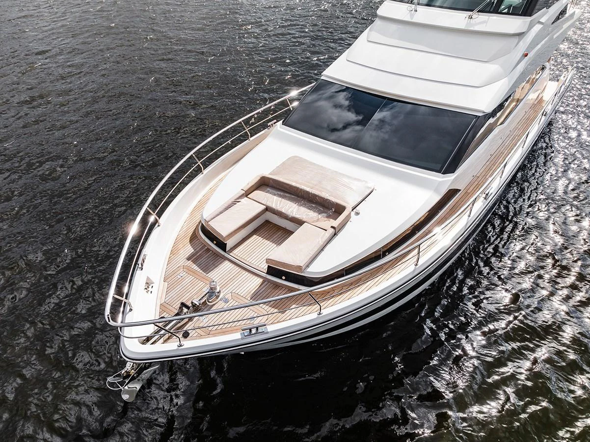 The yacht's foredeck features a sleek design with luxurious sun pads and elegant teak decking. aboard INDIGO Yacht for Sale
