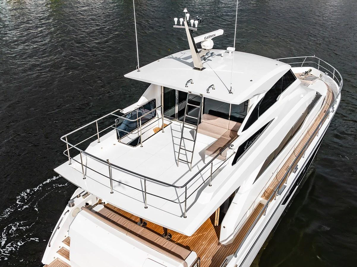The yacht features a spacious flybridge with ample seating and a sleek design. aboard INDIGO Yacht for Sale