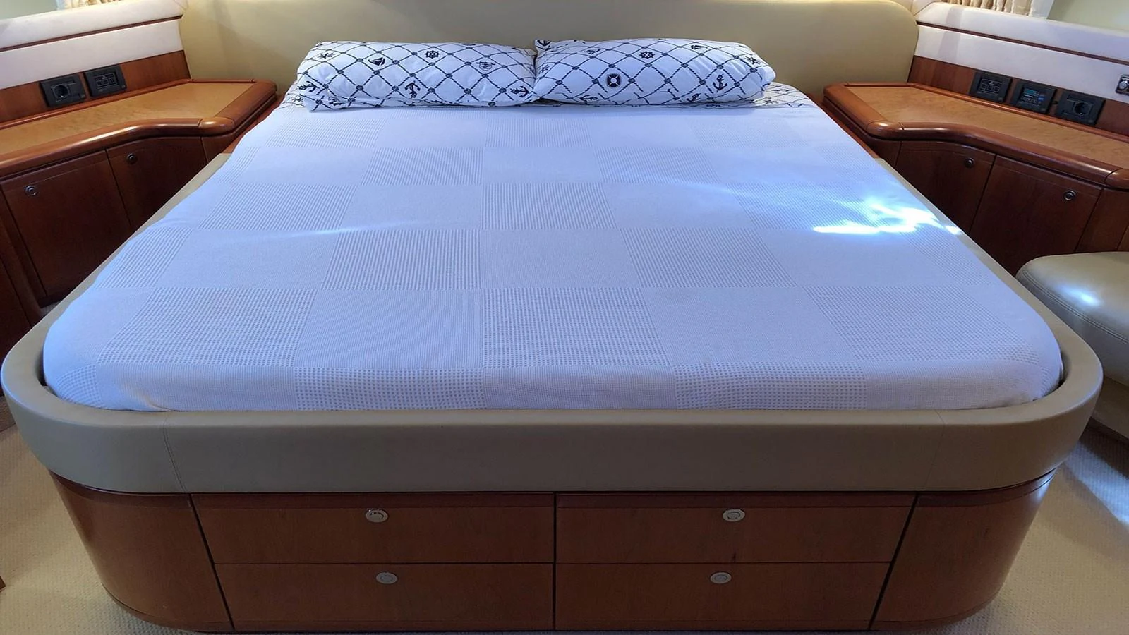 The stateroom features a spacious bed with elegant wooden cabinetry and modern amenities. aboard QUIT Yacht for Sale