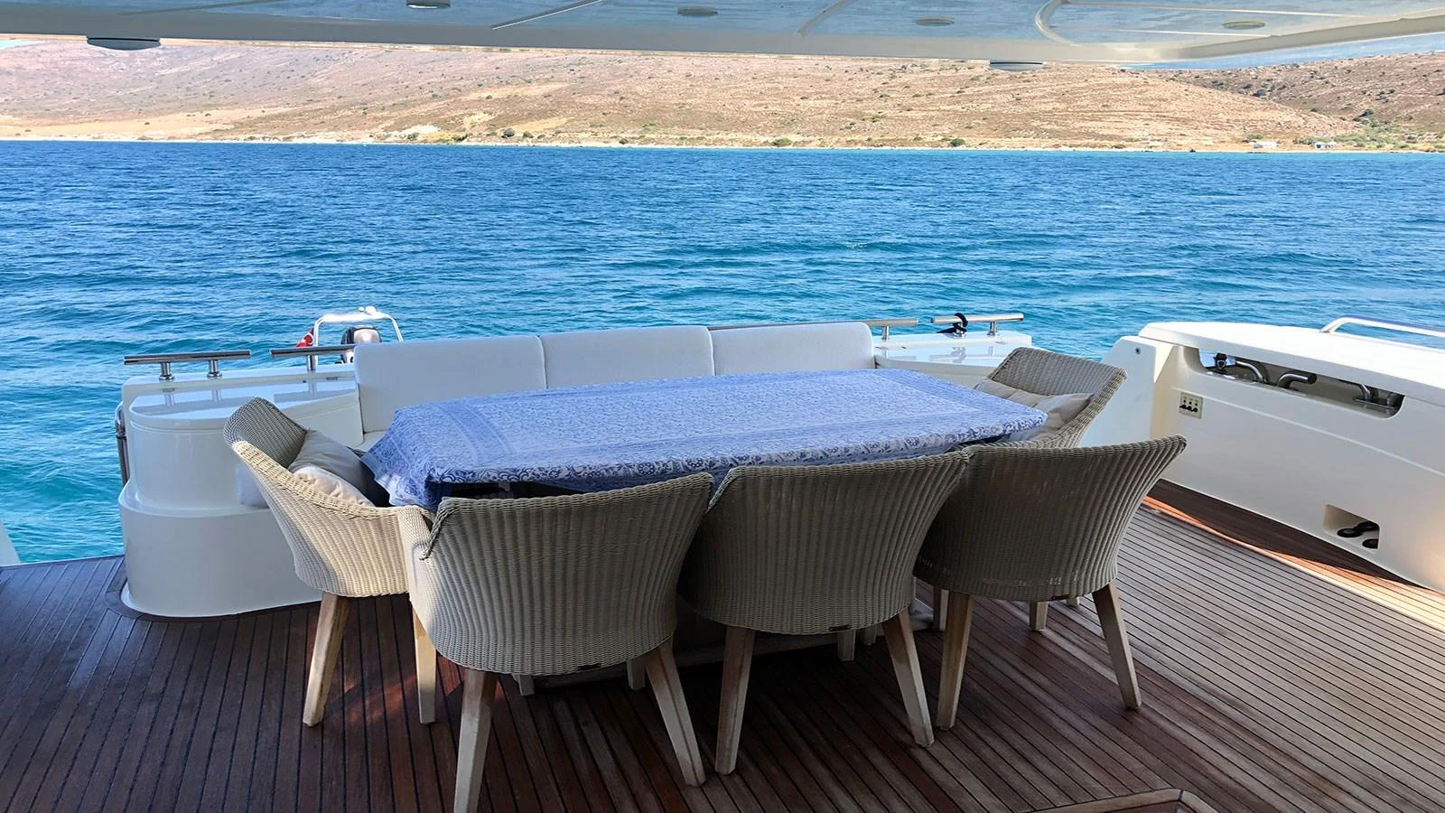 The aft deck features a stylish dining area with a beautiful view of the water. aboard QUIT Yacht for Sale