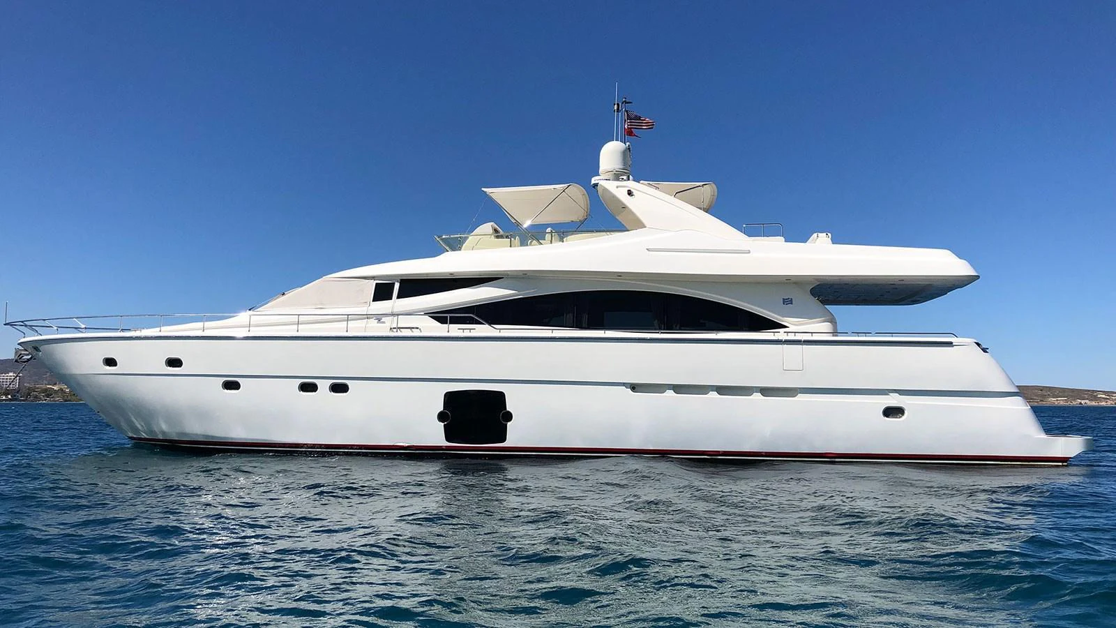 A sleek and modern yacht cruising on clear blue waters under a bright sky. aboard QUIT Yacht for Sale