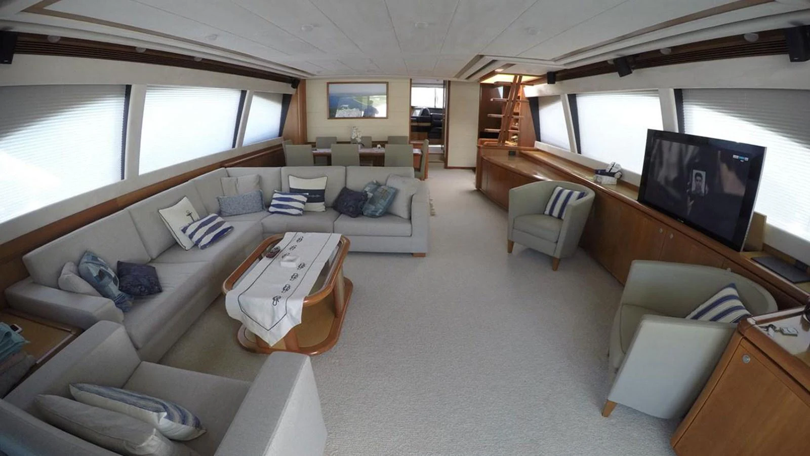 The spacious salon features comfortable seating, a large TV, and elegant decor. aboard QUIT Yacht for Sale