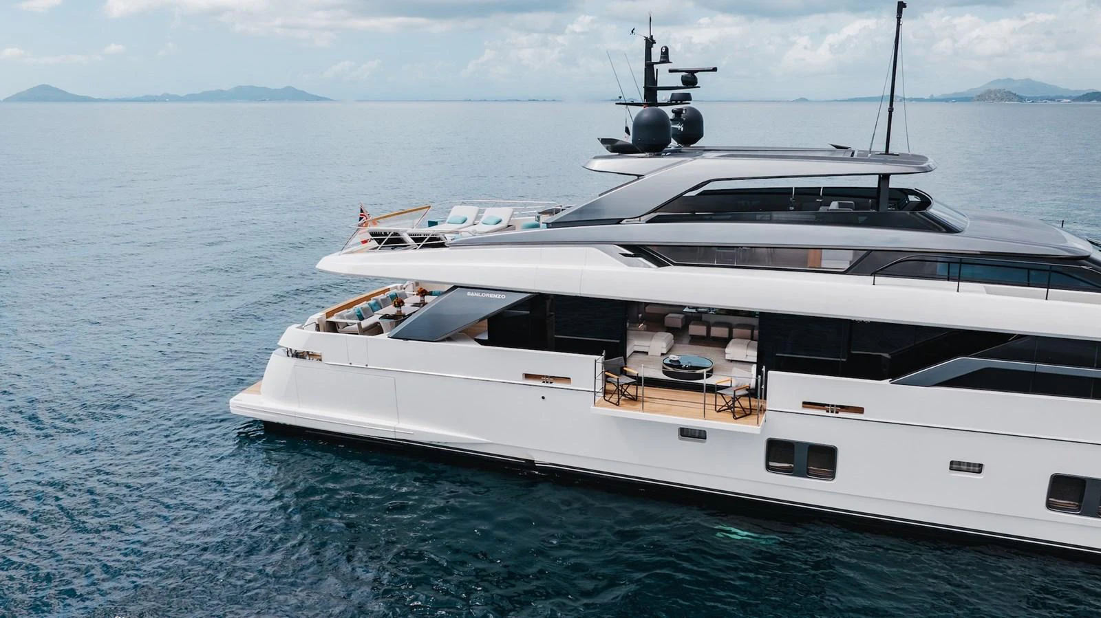 A sleek and modern yacht cruising on calm waters under a partly cloudy sky. aboard AMBAR Yacht for Sale