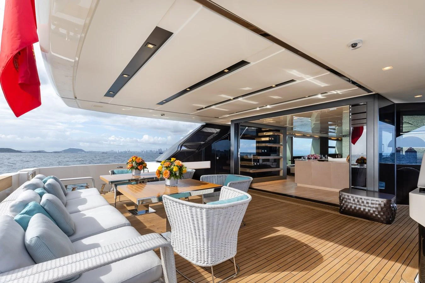 The aft deck offers a luxurious outdoor seating area with a stunning view of the sea. aboard AMBAR Yacht for Sale