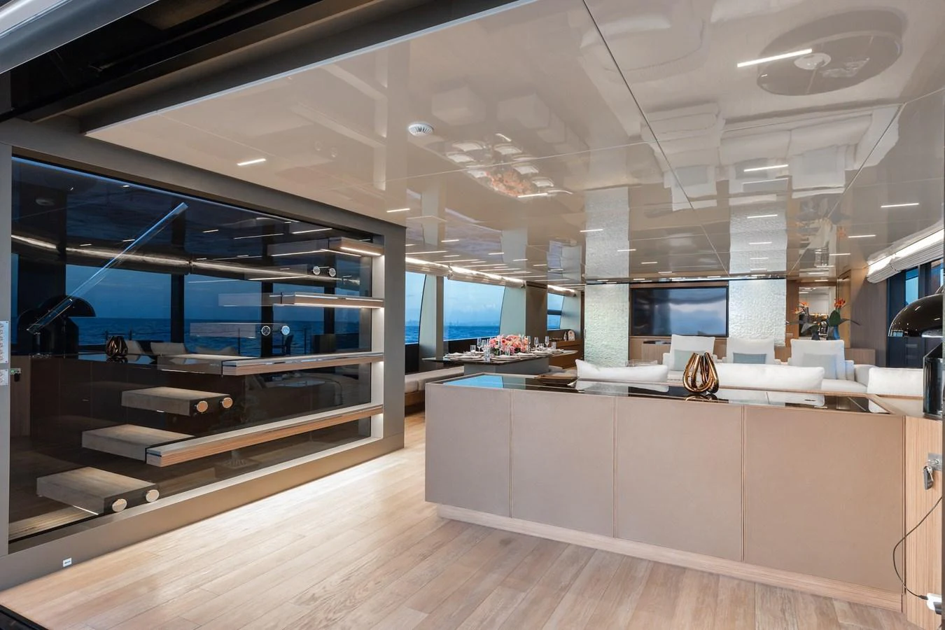 The yacht's salon features modern furnishings and expansive windows offering stunning ocean views. aboard AMBAR Yacht for Sale