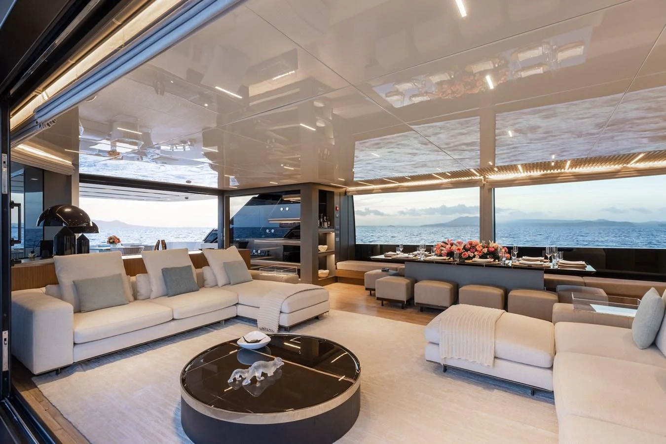 The salon offers a spacious and luxurious area with ample seating and stunning ocean views. aboard AMBAR Yacht for Sale