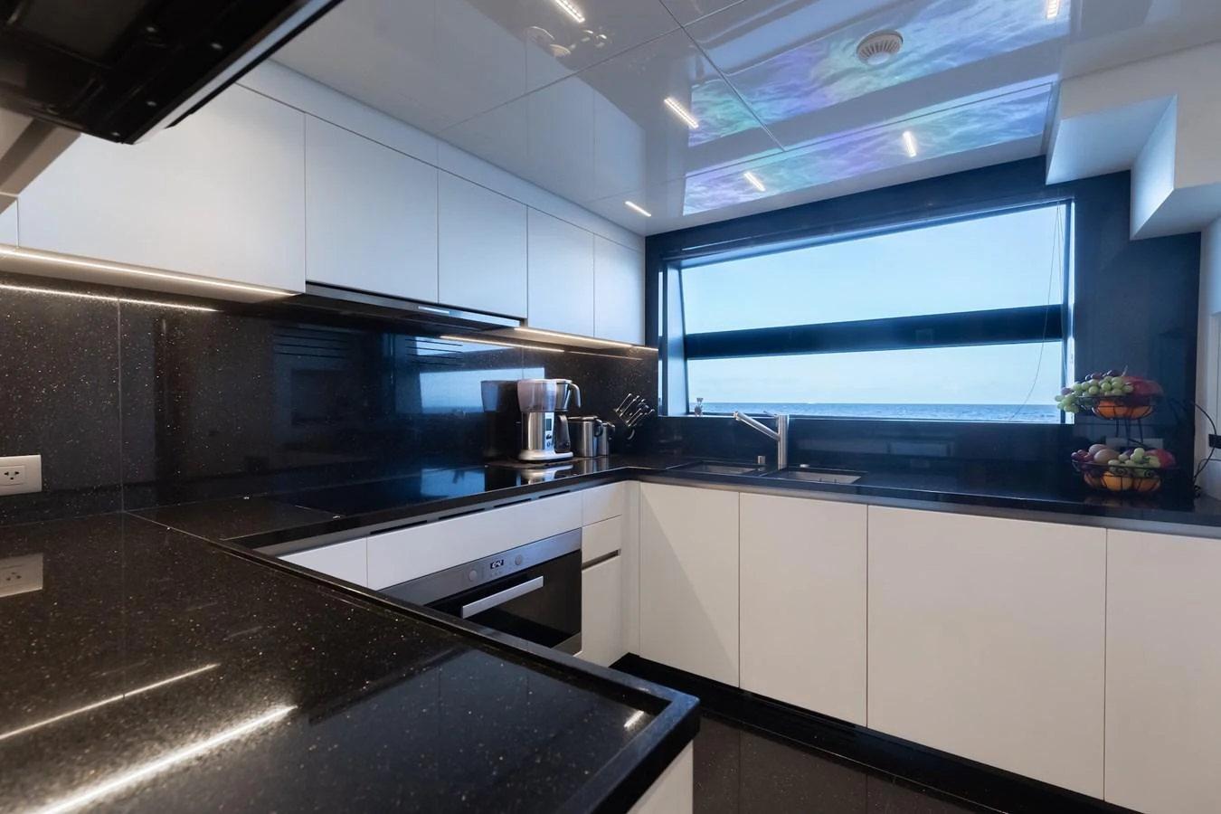 The sleek and modern galley features high-end appliances and a stunning ocean view. aboard AMBAR Yacht for Sale