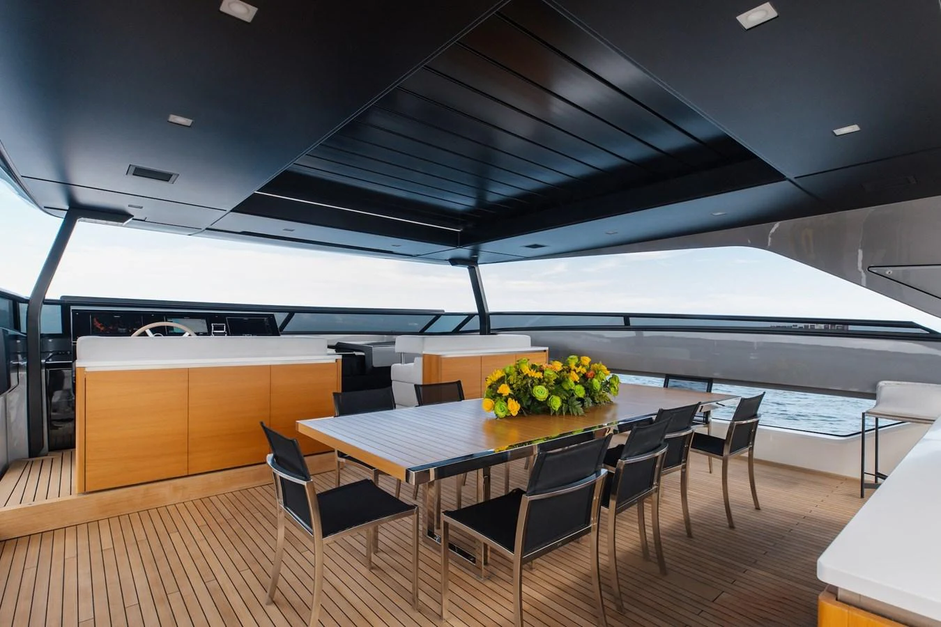 The aft deck features a stylish dining area with a large table and comfortable seating, perfect for alfresco meals. aboard AMBAR Yacht for Sale