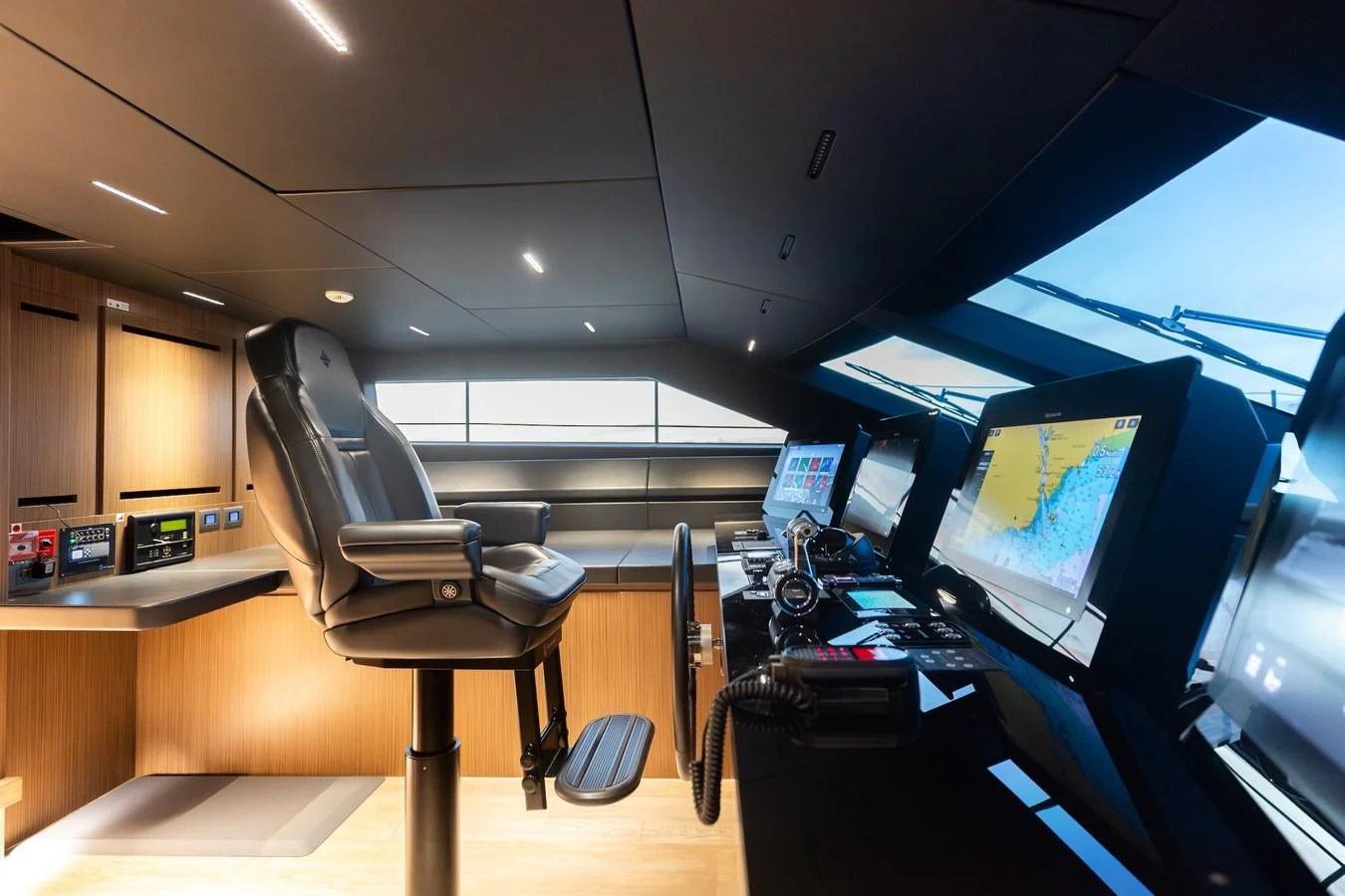 The helm station features advanced navigation equipment and a comfortable captain's chair. aboard AMBAR Yacht for Sale