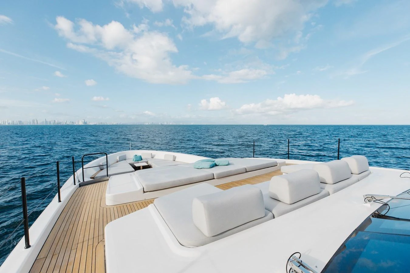 The foredeck offers expansive sunbathing areas with plush cushions and stunning ocean views. aboard AMBAR Yacht for Sale