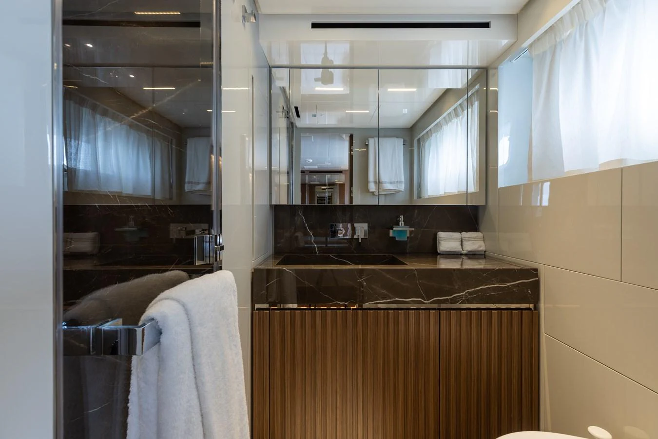 The yacht's bathroom features sleek, modern design with luxurious finishes. aboard AMBAR Yacht for Sale