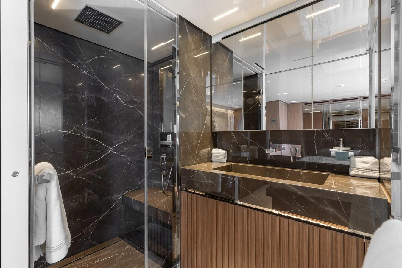 A luxurious bathroom with modern fixtures and elegant marble surfaces. aboard AMBAR Yacht for Sale