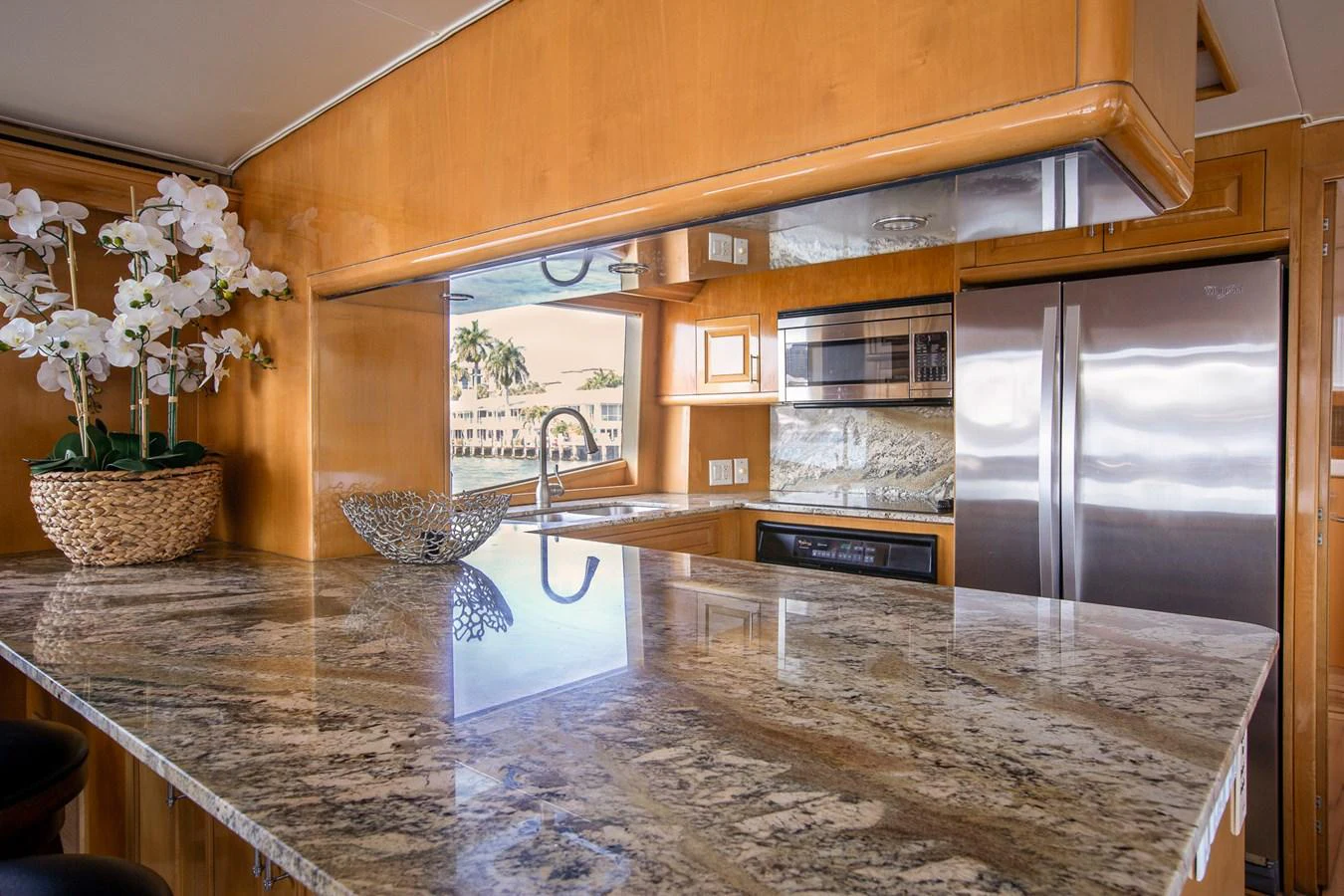 The galley features a luxurious marble countertop and modern stainless steel appliances. aboard KRISTIN LEE Yacht for Sale