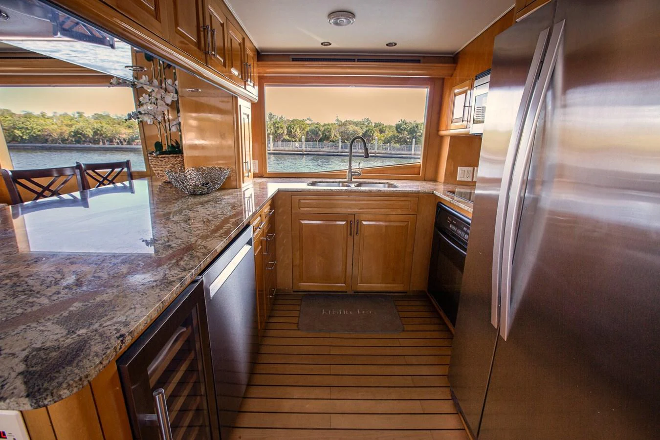 The yacht's galley features modern appliances and a scenic view through large windows. aboard KRISTIN LEE Yacht for Sale