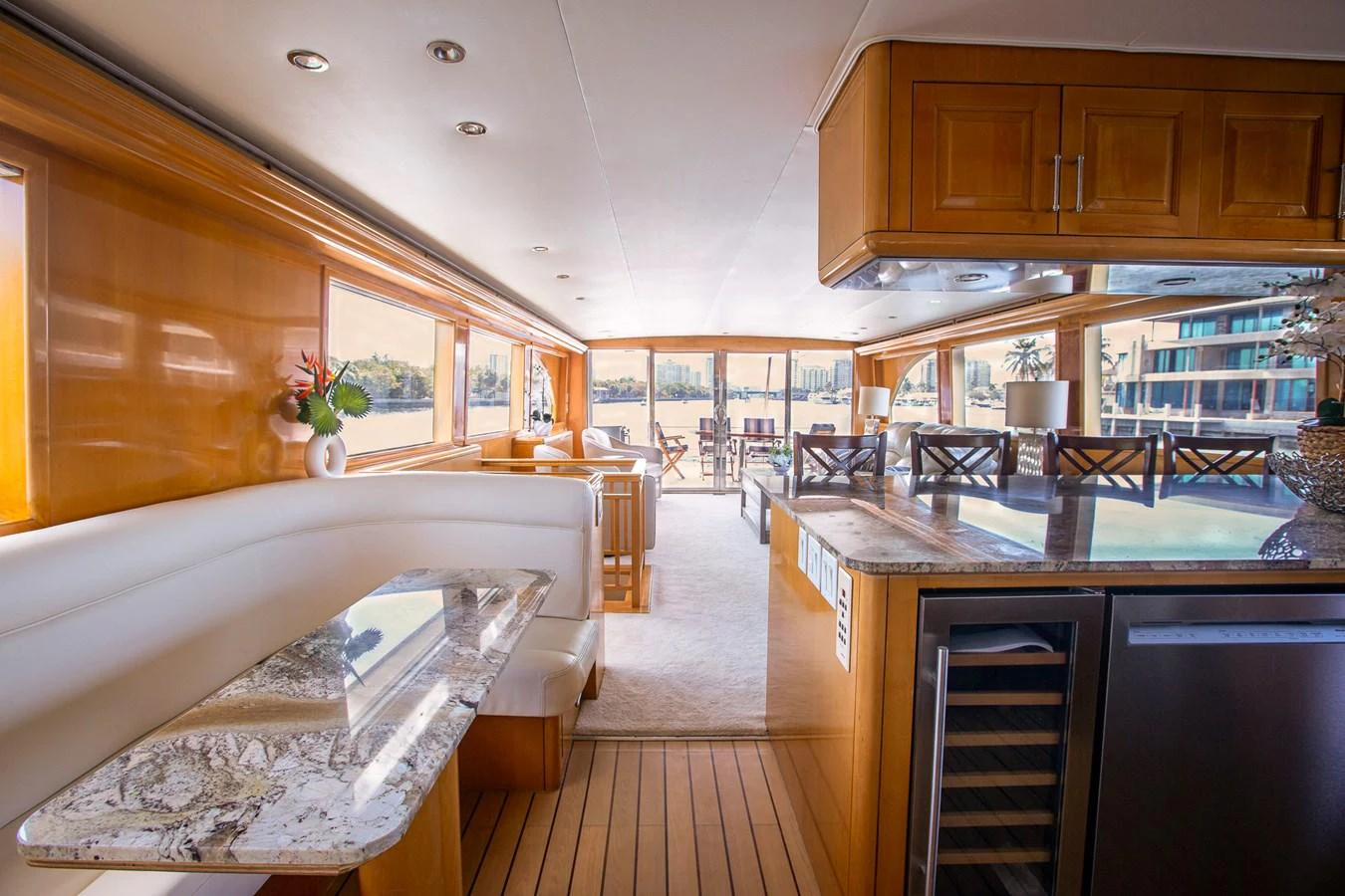 The yacht's salon features elegant wood finishes, plush seating, and ample natural light. aboard KRISTIN LEE Yacht for Sale