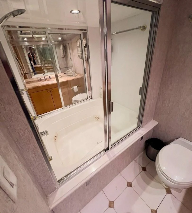 The yacht's bathroom features a sleek design with a glass-enclosed shower and modern fixtures. aboard KRISTIN LEE Yacht for Sale