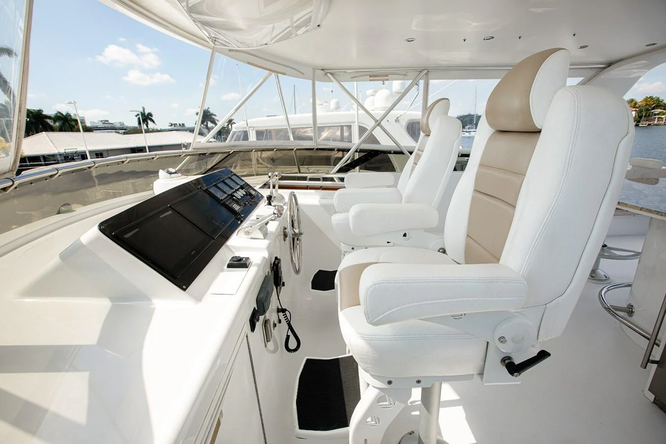 The helm features sleek, modern controls and comfortable seating with a panoramic view. aboard KRISTIN LEE Yacht for Sale