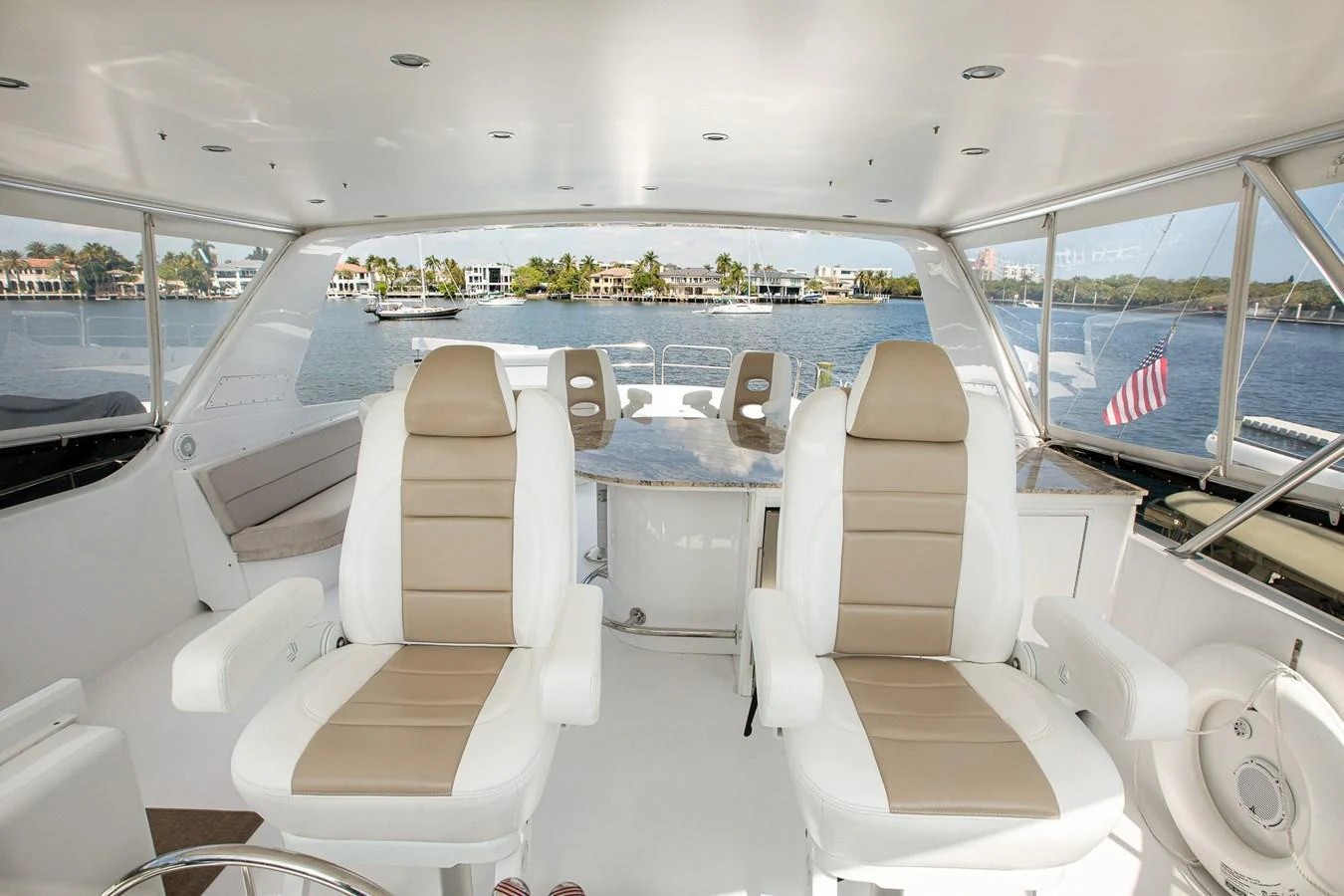 The helm area features comfortable seating with a panoramic view of the water. aboard KRISTIN LEE Yacht for Sale