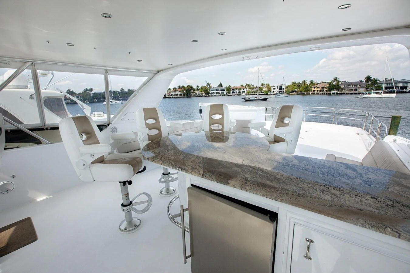 The flybridge offers a spacious and elegant area with comfortable seating and a stunning view of the water. aboard KRISTIN LEE Yacht for Sale