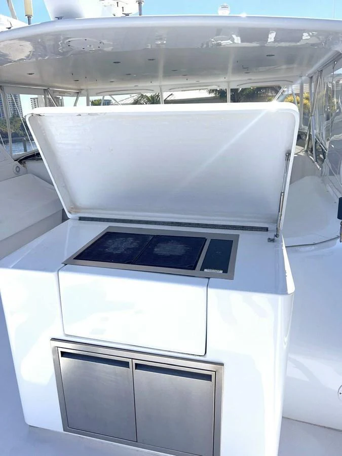 A sleek outdoor cooking station with a grill and storage compartments on a yacht. aboard KRISTIN LEE Yacht for Sale