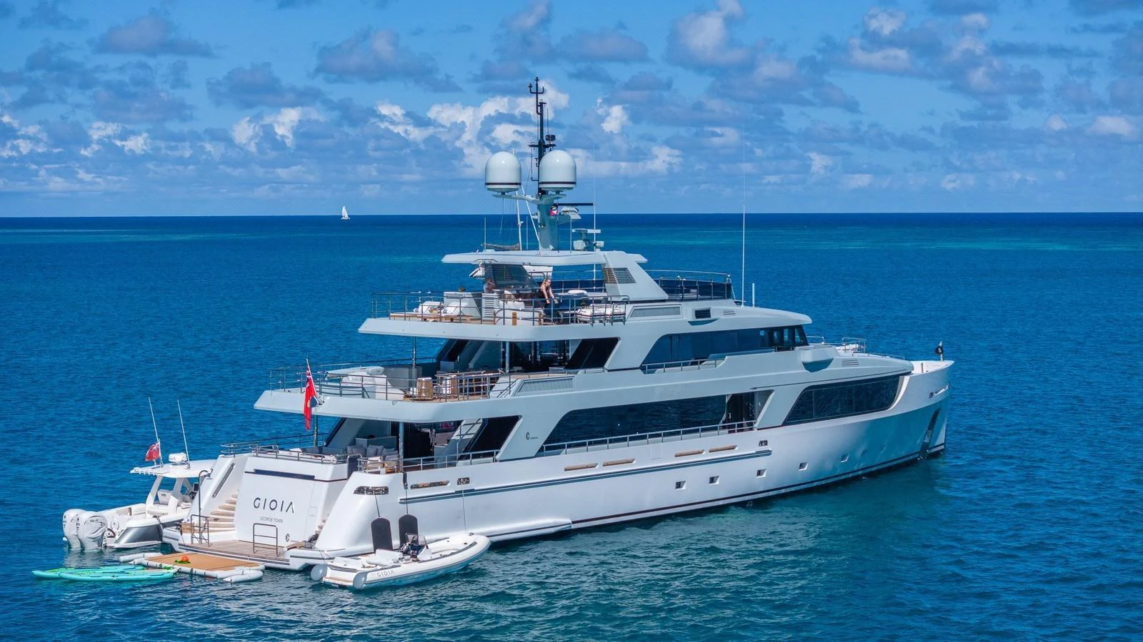 A luxurious yacht anchored in clear blue waters under a bright sky. aboard GIOIA Yacht for Sale