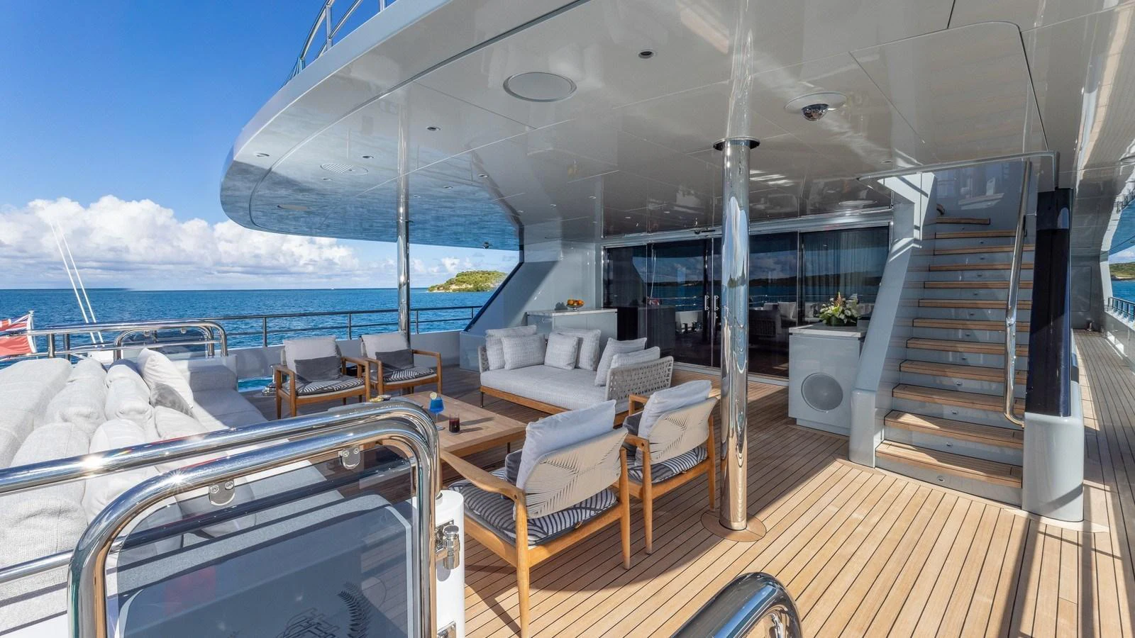 The aft deck offers a spacious and luxurious outdoor seating area with stunning ocean views. aboard GIOIA Yacht for Sale