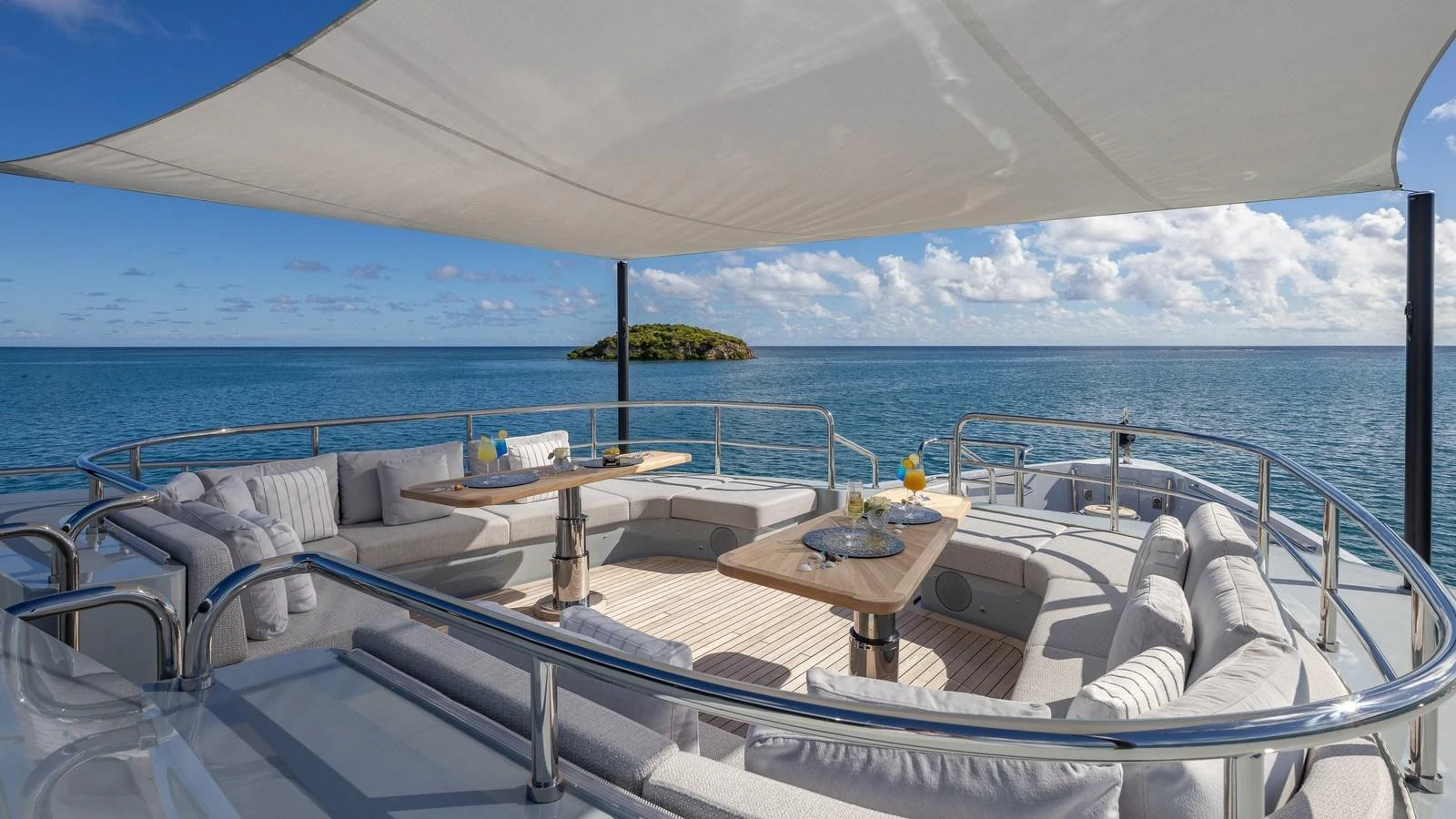 The sundeck offers a luxurious seating area with panoramic ocean views, shaded by a sleek canopy. aboard GIOIA Yacht for Sale