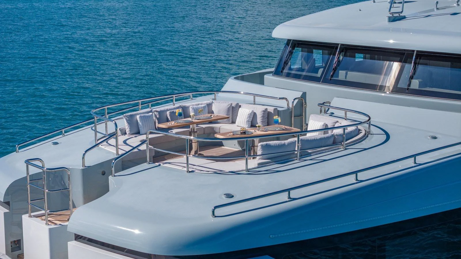 The yacht's foredeck features a spacious seating area with tables, perfect for relaxation and socializing. aboard GIOIA Yacht for Sale