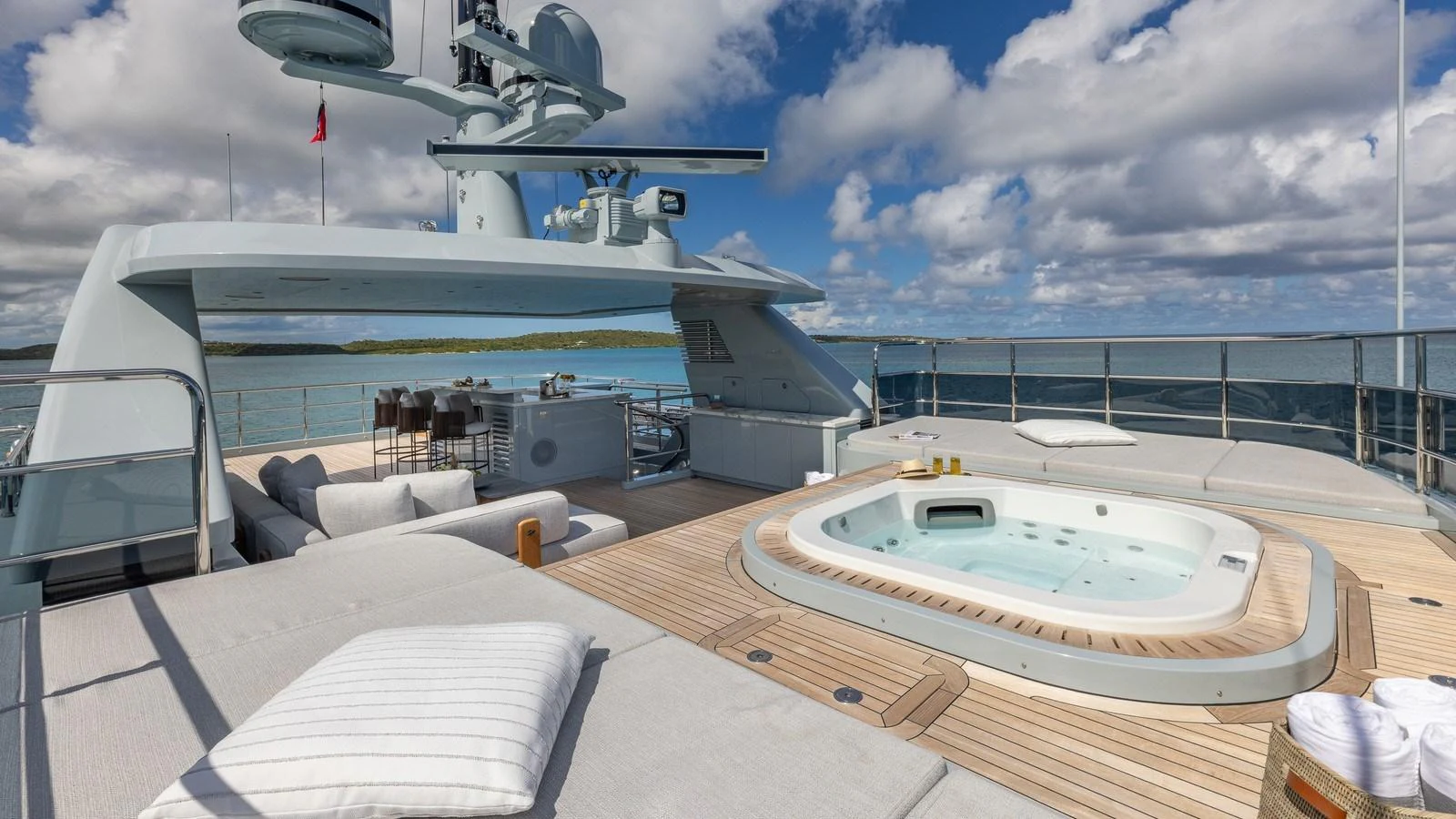 The sundeck features a luxurious jacuzzi and comfortable lounging areas with stunning ocean views. aboard GIOIA Yacht for Sale