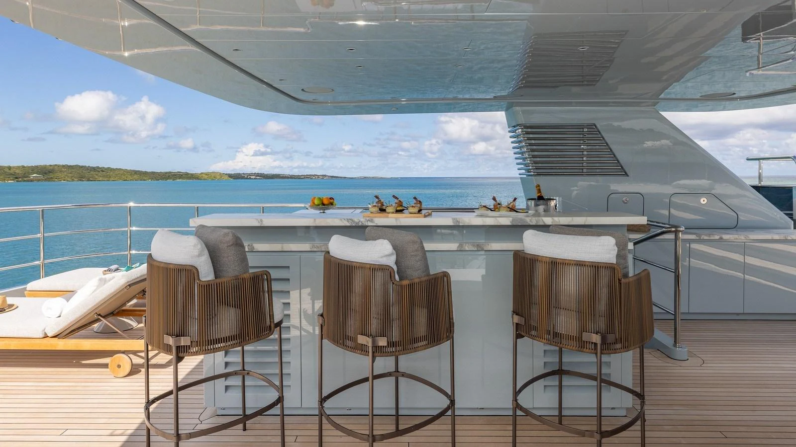 An inviting outdoor bar area with comfortable seating and a stunning ocean view. aboard GIOIA Yacht for Sale
