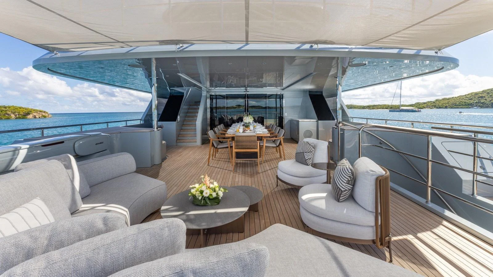 The spacious aft deck features luxurious seating and a dining area with stunning ocean views. aboard GIOIA Yacht for Sale