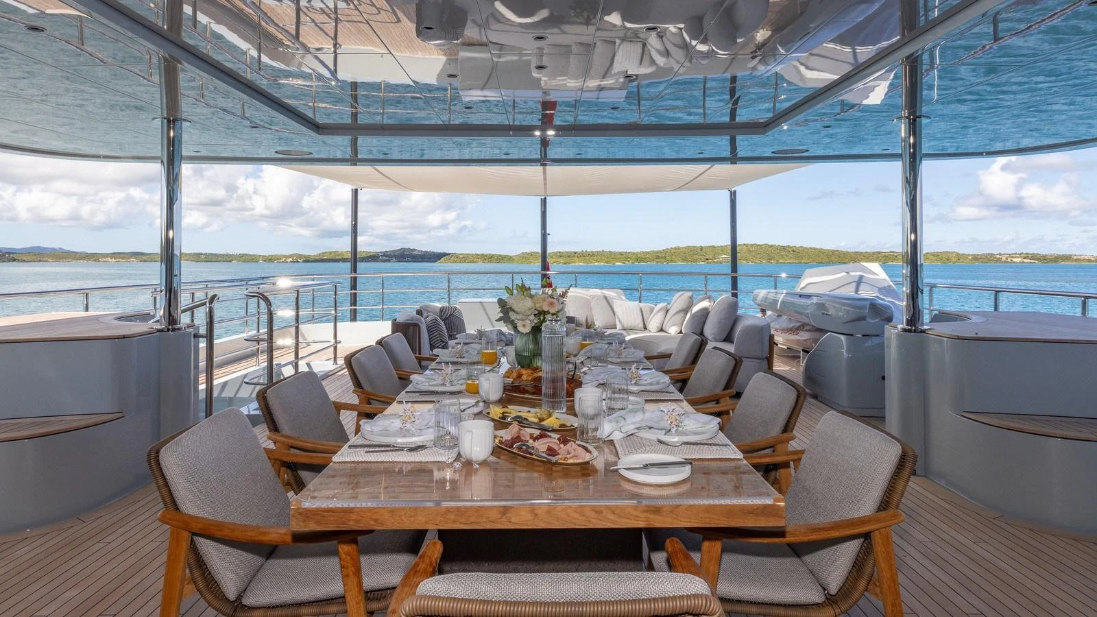 The aft deck features an elegant dining area with a stunning view of the surrounding waters. aboard GIOIA Yacht for Sale