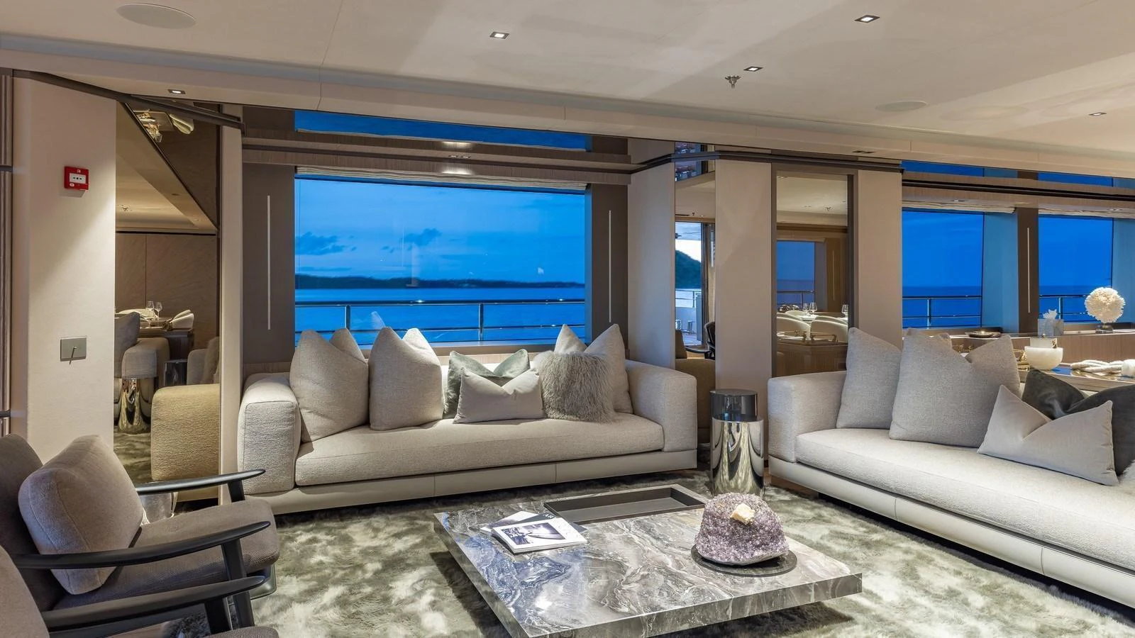 The yacht's salon features plush seating and expansive windows offering stunning ocean views. aboard GIOIA Yacht for Sale