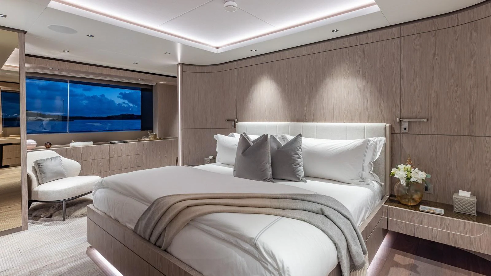 The master stateroom features a luxurious bed with elegant decor and a large window offering stunning views. aboard GIOIA Yacht for Sale