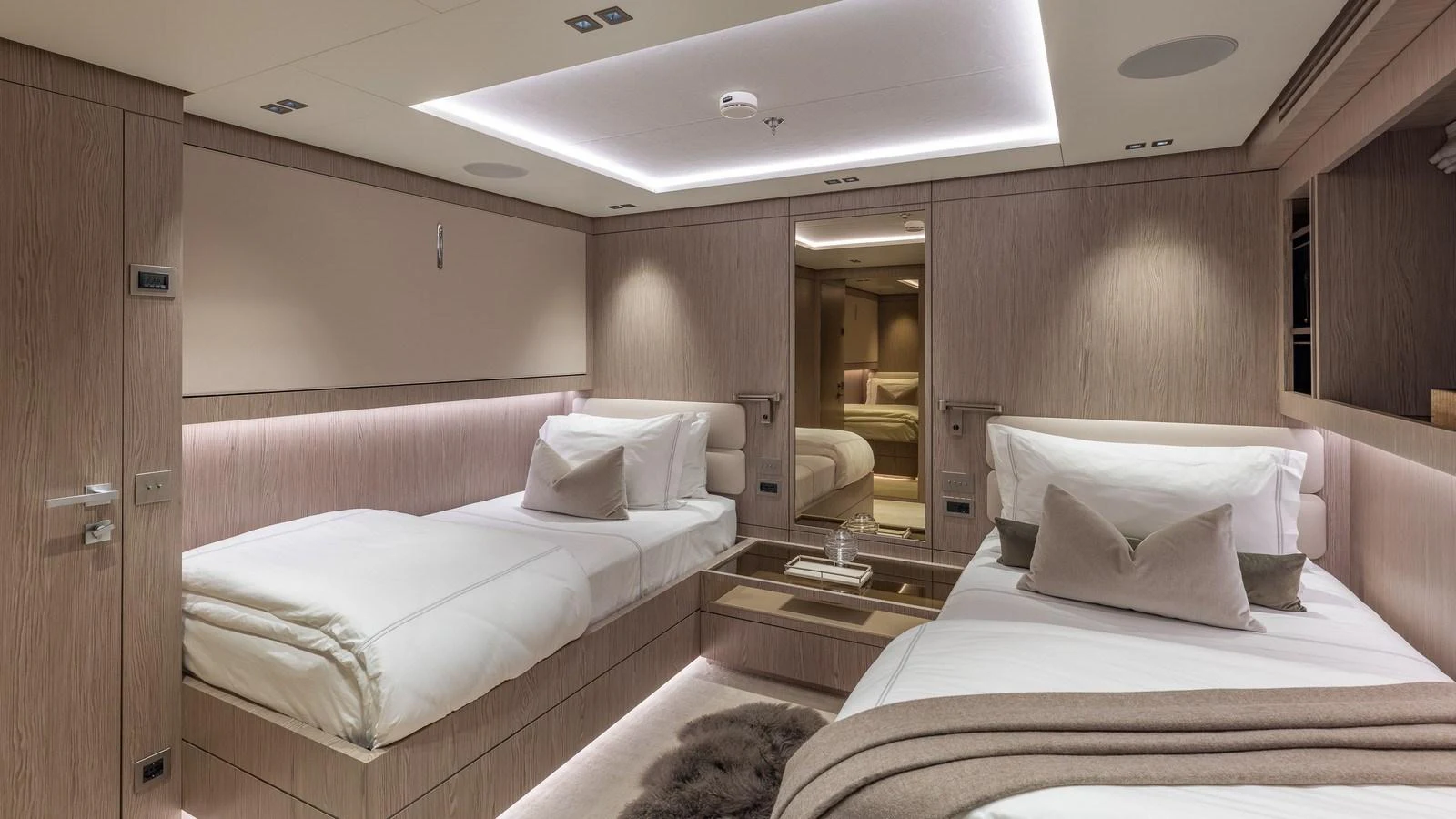 The guest stateroom offers a serene and luxurious retreat with twin beds and elegant lighting. aboard GIOIA Yacht for Sale