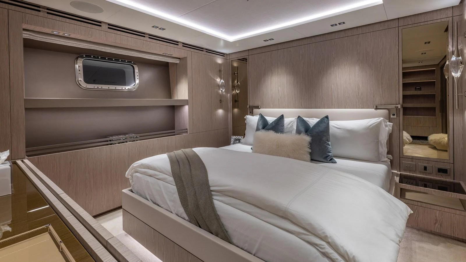 A luxurious stateroom featuring a plush bed with elegant bedding and modern decor. aboard GIOIA Yacht for Sale