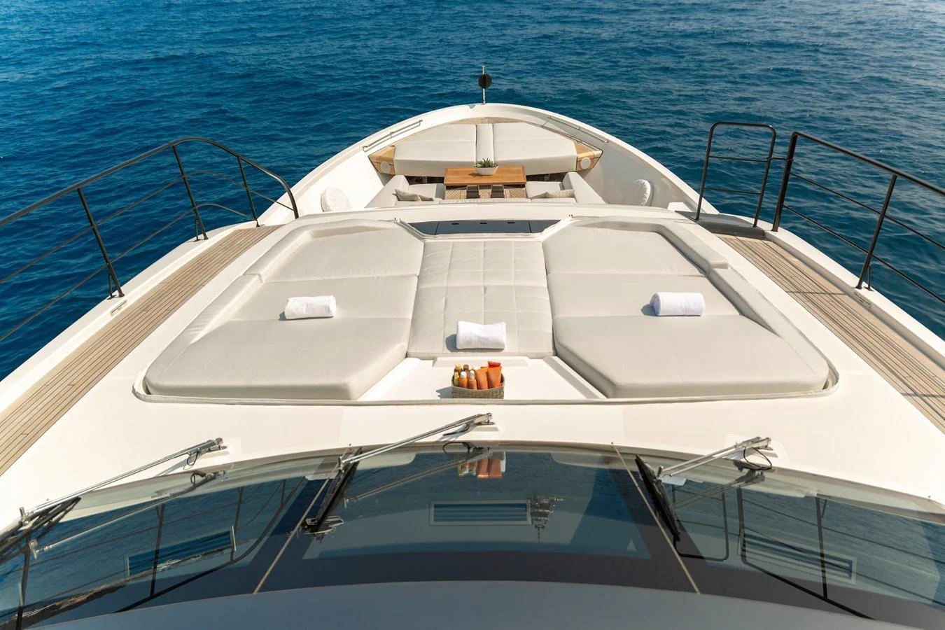 The foredeck features luxurious sun pads and a small table, perfect for relaxation and enjoying the sea view. aboard NANGARA Yacht for Sale