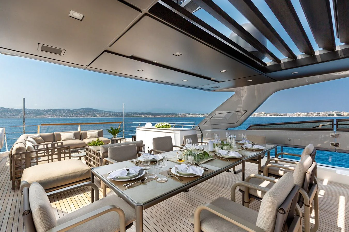 The aft deck features an elegant dining area with stunning ocean views. aboard NANGARA Yacht for Sale