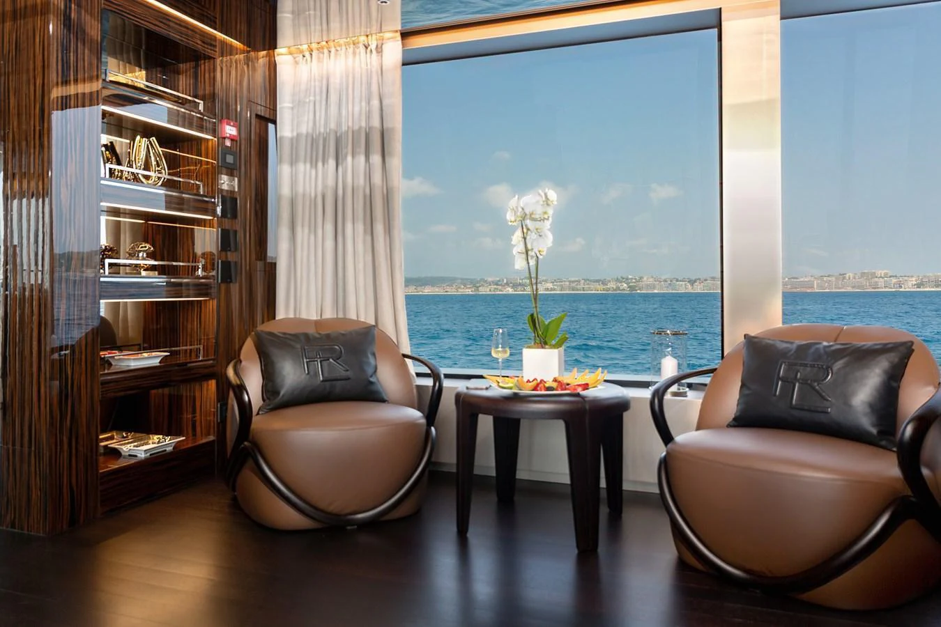 A luxurious interior seating area with a stunning ocean view through large windows. aboard NANGARA Yacht for Sale