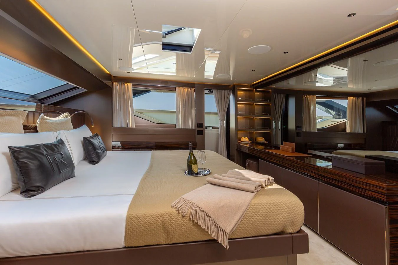 The master stateroom features a luxurious bed, elegant decor, and ample natural light. aboard NANGARA Yacht for Sale