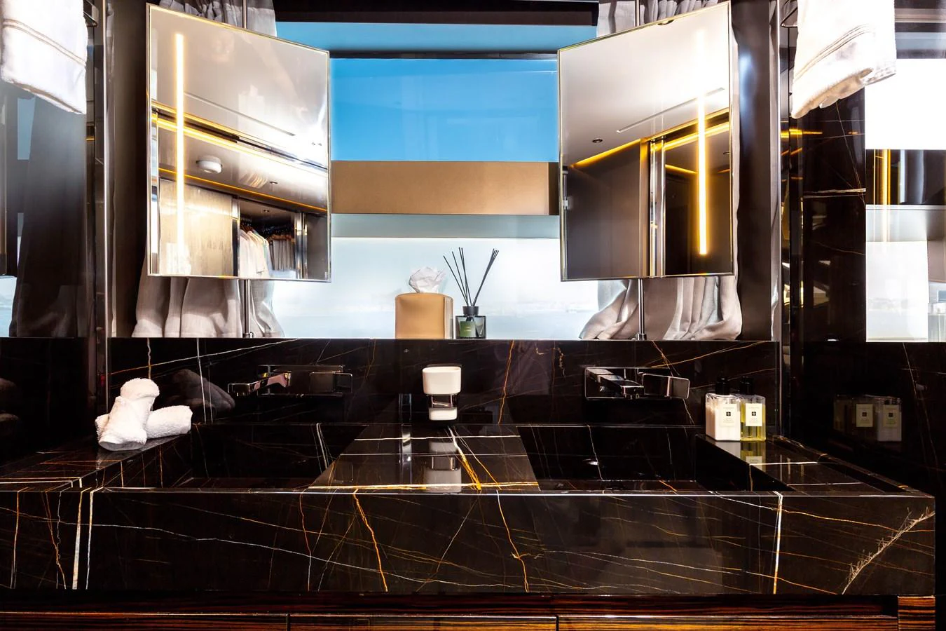 The yacht's bathroom features luxurious black marble surfaces and modern fixtures. aboard NANGARA Yacht for Sale