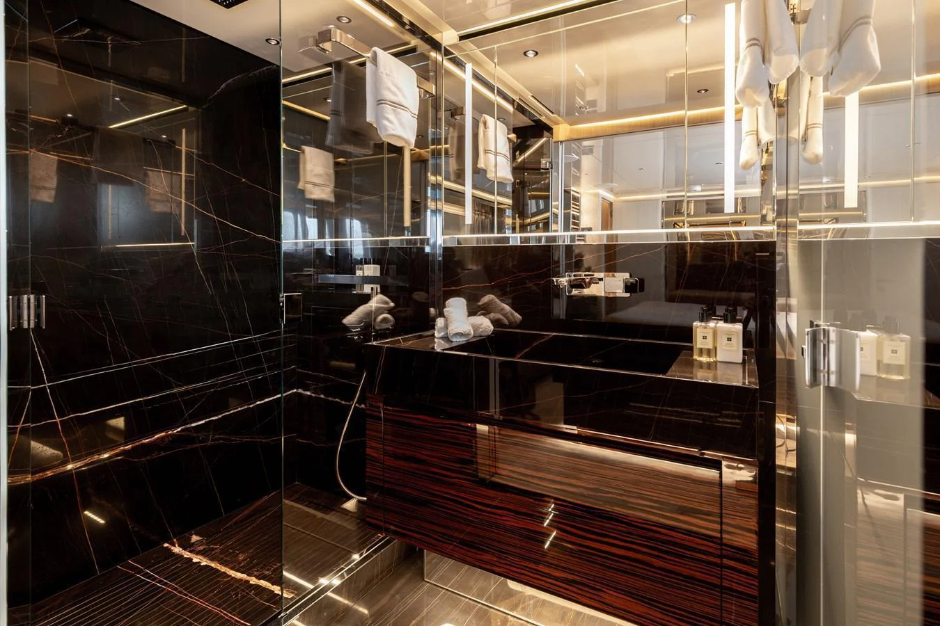 The yacht's bathroom features luxurious finishes with sleek black marble and modern fixtures. aboard NANGARA Yacht for Sale