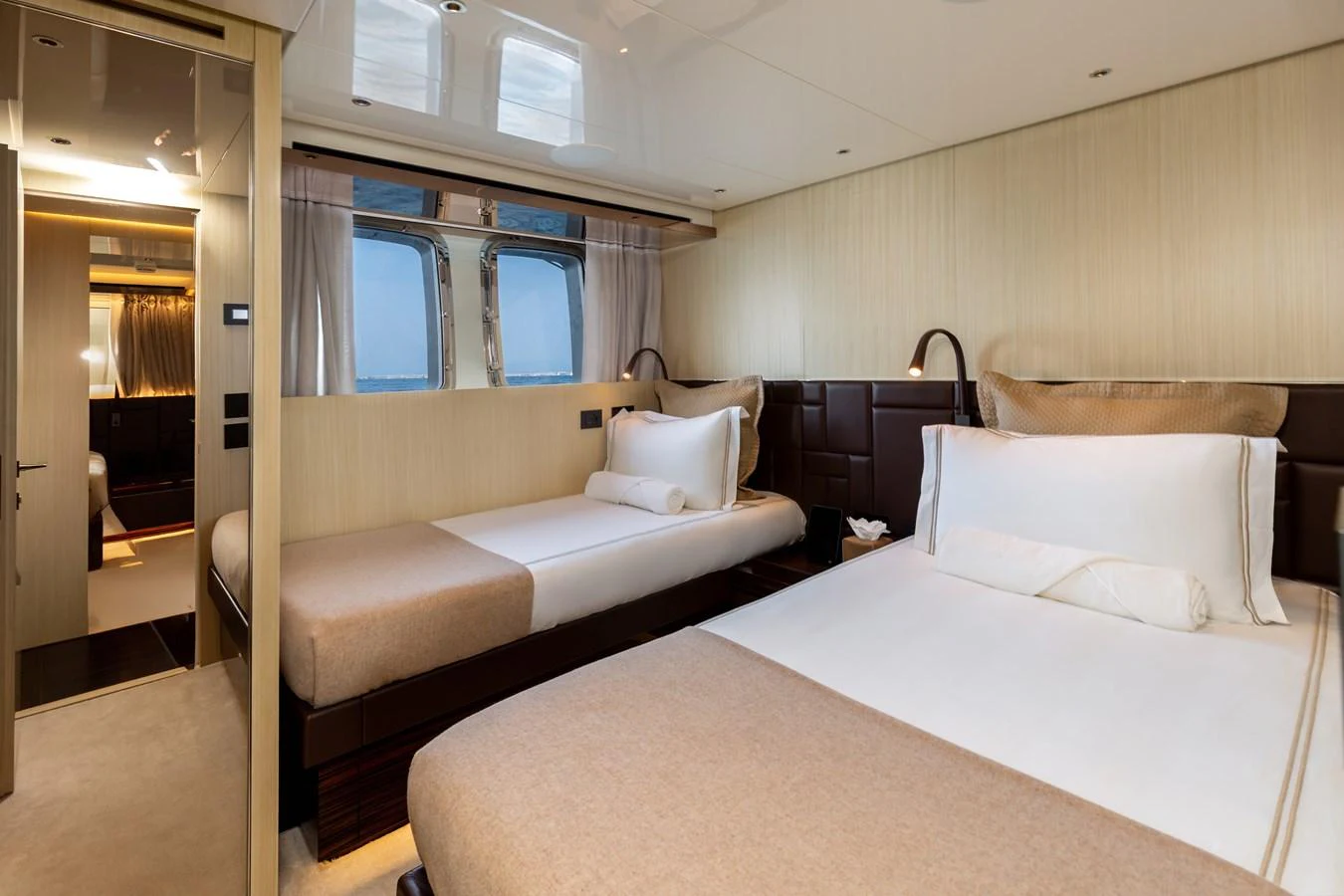 The guest stateroom features twin beds with elegant bedding and a serene ambiance. aboard NANGARA Yacht for Sale